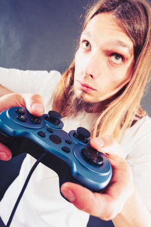 Lifestyle of young people. Student man spending time on playing games videogames console  . Long...