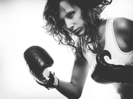 Sportsmanship fairplay and strong body. Young woman fighting boxing with opponent. Sport and fitness healthy lifestyle exercising. Black & whiteの写真素材