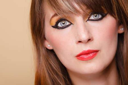 Closeup portrait young attractive orient eastern girl with perfect make-up. Woman with beauty makeup eye liner red lips.の写真素材