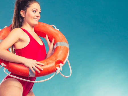 Lifeguard with ring buoy lifebuoy. Woman girl supervising swimming pool water on blue. Accident...