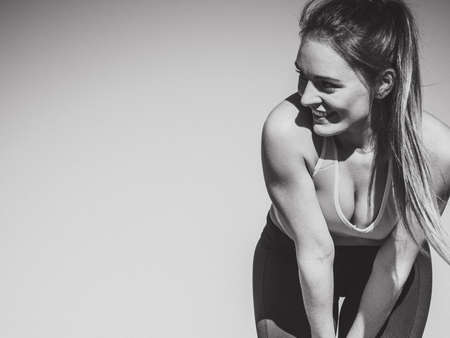 Beauty sporty slim girl training outdoor. Young attractive happy girl posing in sports clothing.の写真素材