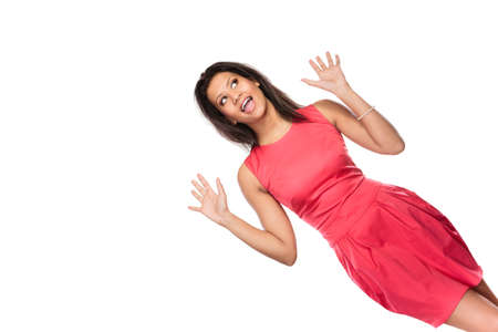 Happy glad young mixed race woman girl enjoying raising arms in victory isolated on white. Joy and happiness.の写真素材