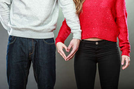 Love concept. Woman and man hands forming heart shape with their fingersの写真素材