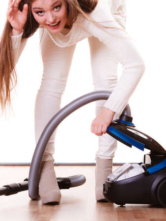 Woman vacuuming the house. Funny girl with vacuum cleaner. Houseworkの写真素材