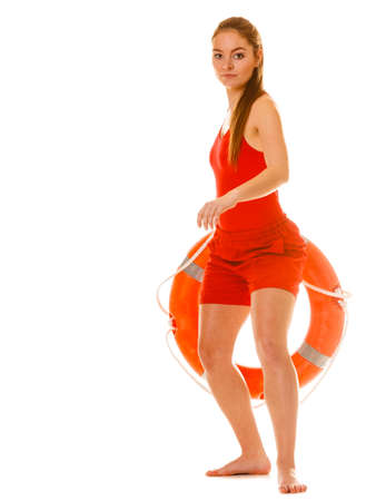 Lifeguard with ring buoy lifebuoy. Woman supervising swimming pool water. Accident prevention.の写真素材