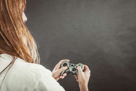Addiction and dependency concept. Young man with pad joystick playing games. Male addicted to console playstation videogames.の写真素材