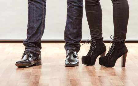 Legs of woman and man. Closeup feet in footwear shoes indoorの写真素材
