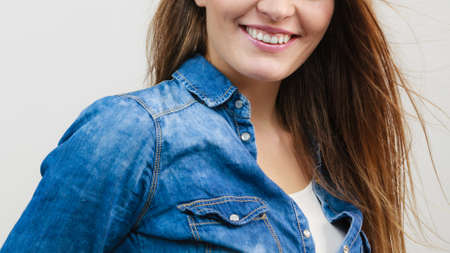 Happiness and joy. Smiling positive girl portrait. Charming joyful woman wearing fashionable stylish denim jeans clothes.の写真素材