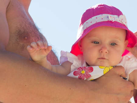 Closeup of sweet little baby in parent hands. Babyhood and parenting.の写真素材
