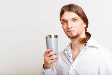 Alcohol liquor drinking relax party concept. Male barman makes cocktail. Young bartender holding...