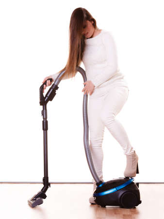 Woman vacuuming the house. Funny girl with vacuum cleaner. Houseworkの写真素材