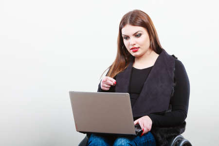 Crippled lady with laptop. Young disabled girl on wheelchair. Health disability internet technology...