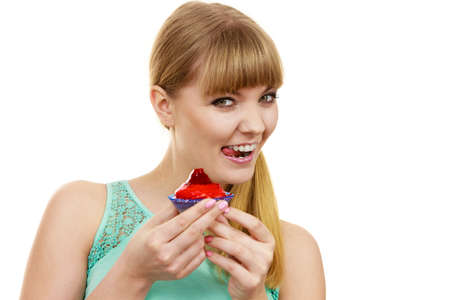 Woman holds cake cupcake in hand unhealthy food snack. Bakery sweet eating happiness and people...