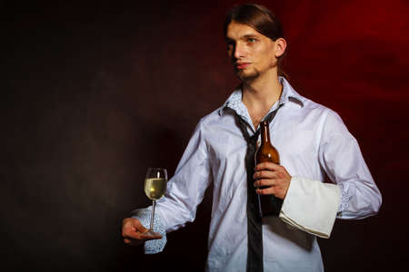 Drink winery liquor relax concept. Waiter serving wine bottle. Steward holds glass with alcohol beverage.の写真素材