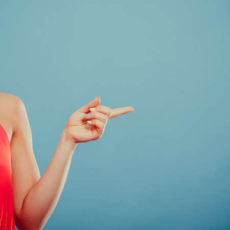 Human hand showing blank empty copyspace on blue. Advertisement.の写真素材