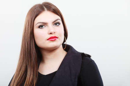 Young beauty woman portrait. Pensive attractive brunette wearing dark black clothes.の写真素材