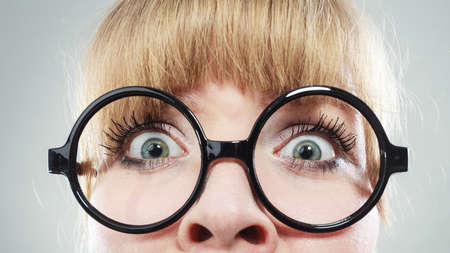Scared afraid woman with eyes wide open. Part of face, closeup.の写真素材