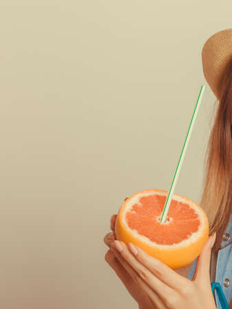 human holding grapefruit citrus fruit. refreshing drink. healthy diet food. summer vacation holiday concept.の写真素材