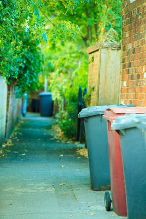 Row of plastic wheely bins in the street outside houses in Englandの写真素材