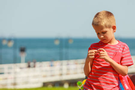 Leisure and free time concept. Portrait of little boy spending time outside on fresh air. Male kid outdoor on holidays vacation.の写真素材