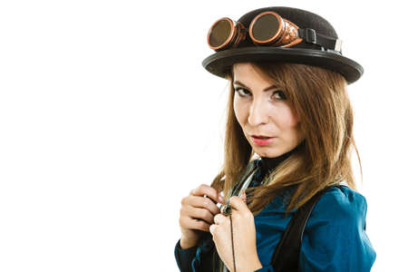 Young steampunk islolated girl on white wearing fancy hat. Fantasy old fashion with stylish bowler and goggle.の写真素材