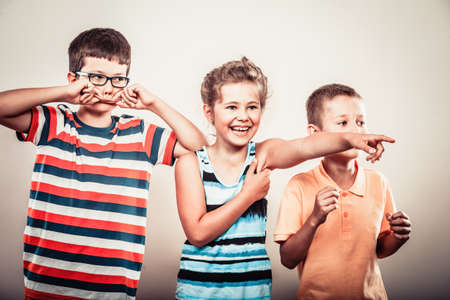 Portrait of happy smiling sweet cute kids little girl and boys in studio. Childhood happiness.の写真素材