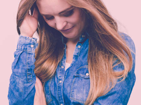 Fashion, beauty, people, jeans concept. Beautiful model posing in the studio. Young lady wearing denim shirt.の写真素材