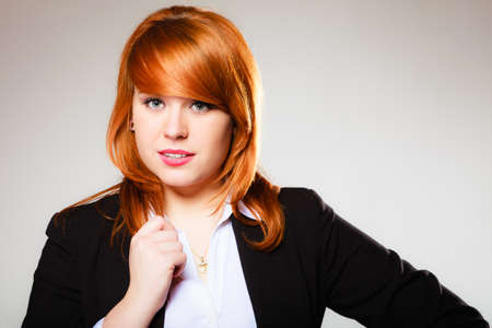 Portrait of beauty redhair business woman or student girl. Studio shot on gray background