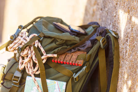 Hiking backpack camping and mountain exploring tourist equipment outdoor on grunge wall. Adventure, summer, tourism active lifestyleの写真素材