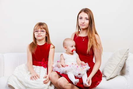 Beauty of motherhood. Happy positive family sitting together. Mommy with two little girls daughters. Three lovely women.の写真素材