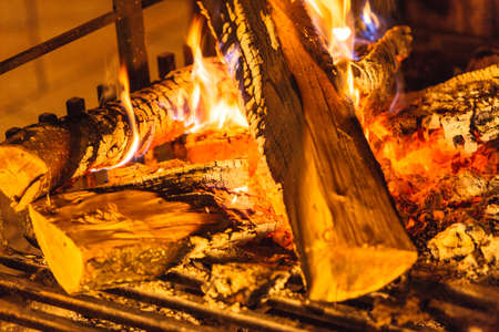 Closeup of burning fire wood in home fireplace.