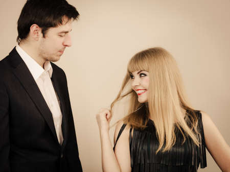 Date flirt and love concept. Valentine's Day. Attractive blonde woman with handsome man dating. Elegant glamorous couple pare fall in love.の写真素材