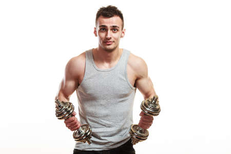 Bodybuilding. Strong fit man exercising with dumbbells. Closeup muscular young guy lifting weights white backgroundの写真素材