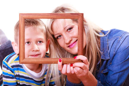 Spending time family bonds parenthood. Mother and son have fun play with empty picture frame hold in hand.の写真素材