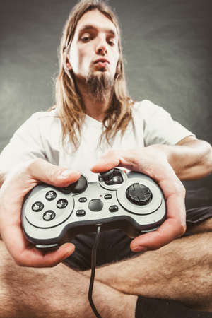 Lifestyle of young people. Student man spending time on playing games videogames console. Long...