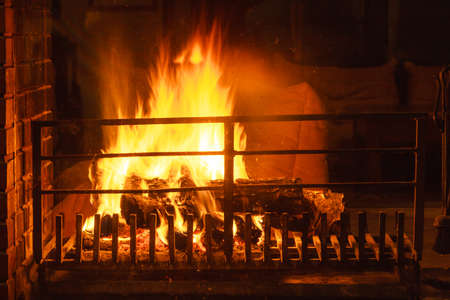 Closeup of burning fire wood in home fireplace.