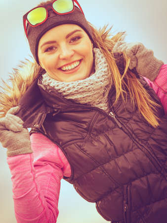 Woman resting relaxing after doing sports outdoors. Fitness girl female jogger wearing warm sporty...