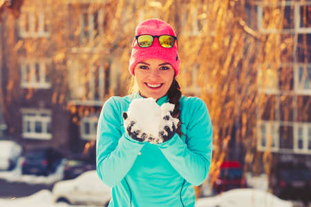 Girl with snow in city. Relax with nature in winter park. Health fitness fashion concept.の写真素材