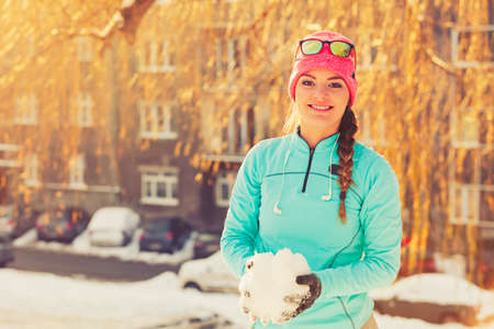 Girl with snow in city. Relax with nature in winter park. Health fitness fashion concept.の写真素材