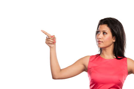 Pretty mixed race woman pointing at empty blank copy space. Girl isolated on white. Advertisement.の写真素材