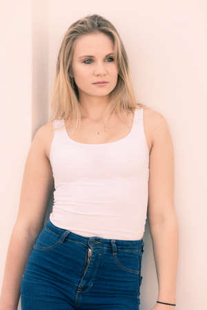 Beauty of female. Young cute beautiful woman posing outside. Attractive girl wearing white t-shirt.