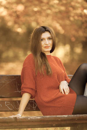 Nature outdoor relax leisure scenery concept. Woman chilling on bench. Young girl sitting in...