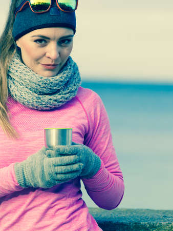 Woman athlete fit girl wearing warm sporty clothes outdoor in cold weatherの写真素材