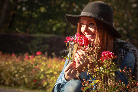 Relax and gardening. Lovely cute young woman spending time in garden. Cheerful beauty girl with pink...