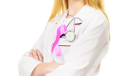 Healthcare, medicine and breast cancer awareness concept. Doctor with stethoscope and pink ribbon aids symbol on chest closeupの写真素材