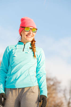 Girl working out in park. Keeping your fitness during winter. Health nature fit concept.の写真素材