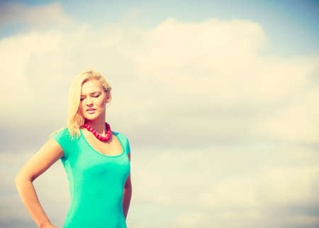 Sumer time, leisure concept. Beautiful woman standing with costume. Lady enjoying good sunny weather outside.の写真素材