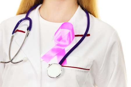 Healthcare, medicine and breast cancer awareness concept. Doctor with stethoscope and pink ribbon aids symbol on chest closeupの写真素材