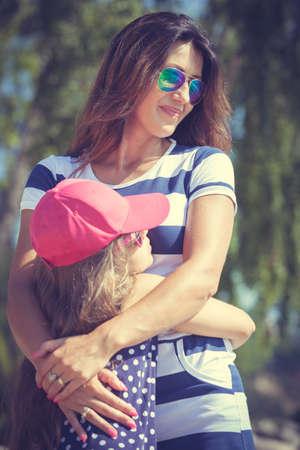 Love and good feelings in family. Childhood and parenthood concept. Lovely cute girl and woman in summer holidays. Adorable mommy and her child daughter together.の写真素材
