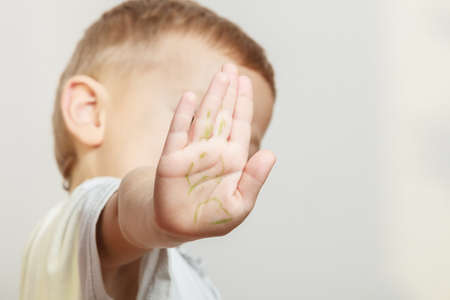 Express negative emotions. Childhood and feelings. Little boy show hand outstretched arm with stop gesture. Hold hand in air.の写真素材